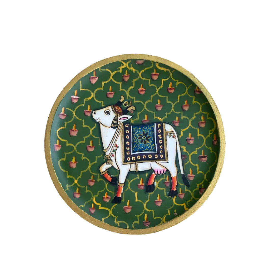 Decorative plate with a cow illustration on a textured surface