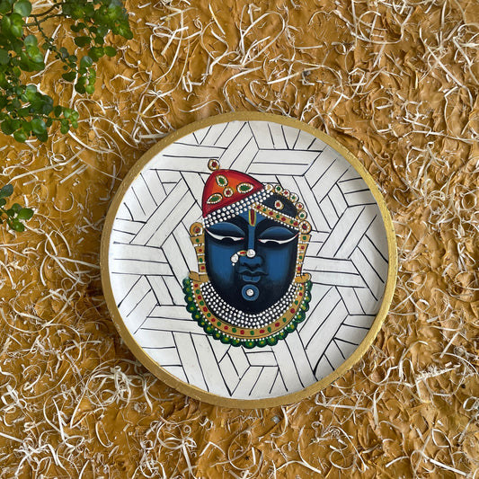 Decorative mask with intricate patterns on a textured gold background