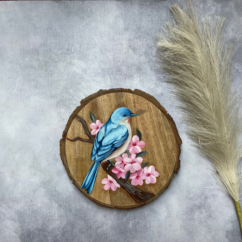 Blossom Whisper – Handpainted Bluebird on Wooden Log with Cherry Blossoms